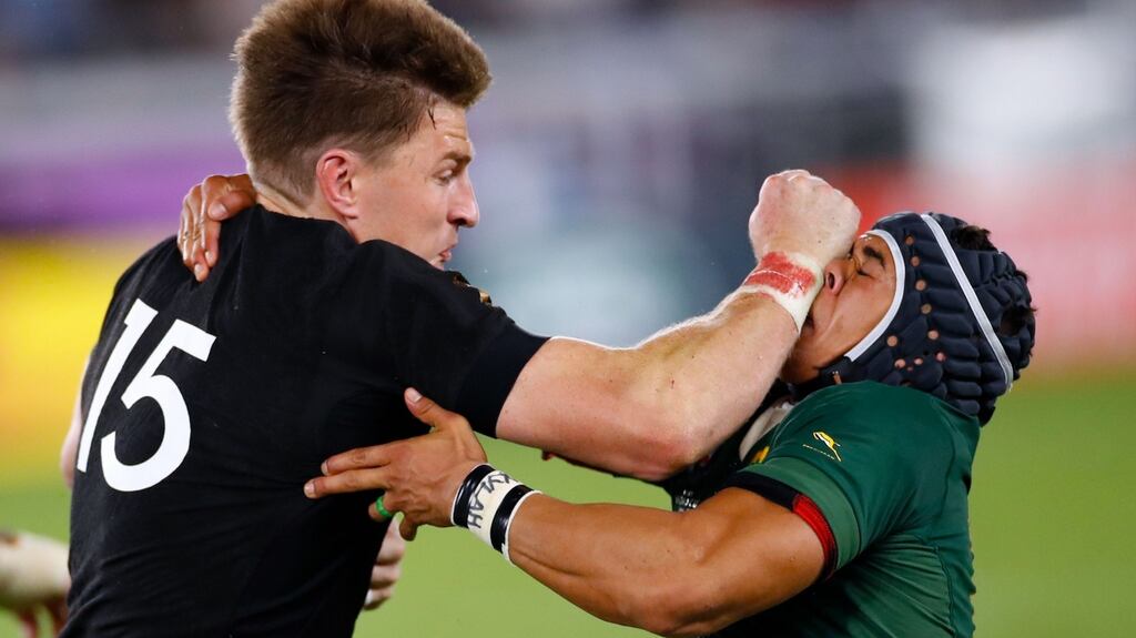 New Zealand fullback Beauden Barrett hands off South Africa wing Cheslin Kolbe during the Rugby World Cup Pool B at the International Stadium Yokohama. Photograph: Odd Andersen/AFP/Getty Images