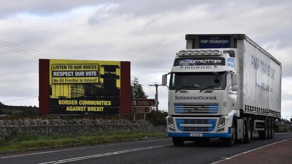 A lorry crosses the Border past a Border Communities Against Brexit billboard in Newry on October 9th, 2018 Photograph: Charles McQuillan/Getty