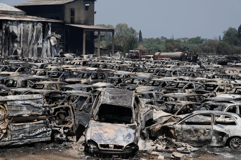 Impounded cars burnt in a wildfire near Patras. Photograph: Thanassis Stavrakis/AP