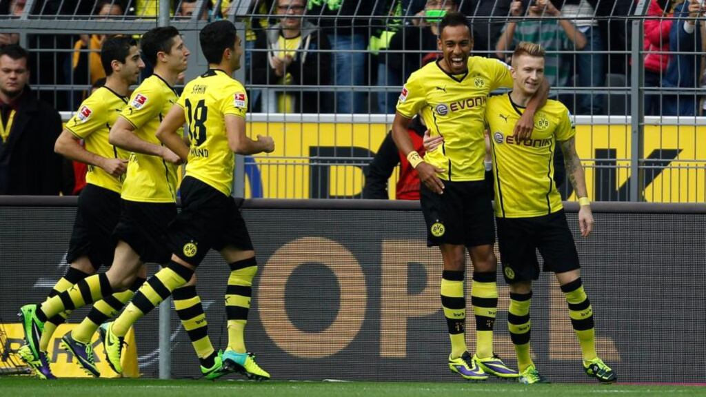 Dortmund’s Marco Reus (right) and Pierre-Emerick Aubameyang (second-right) celebrate a penalty against Hanover. Photograph: Ina Fassbender/Reuters