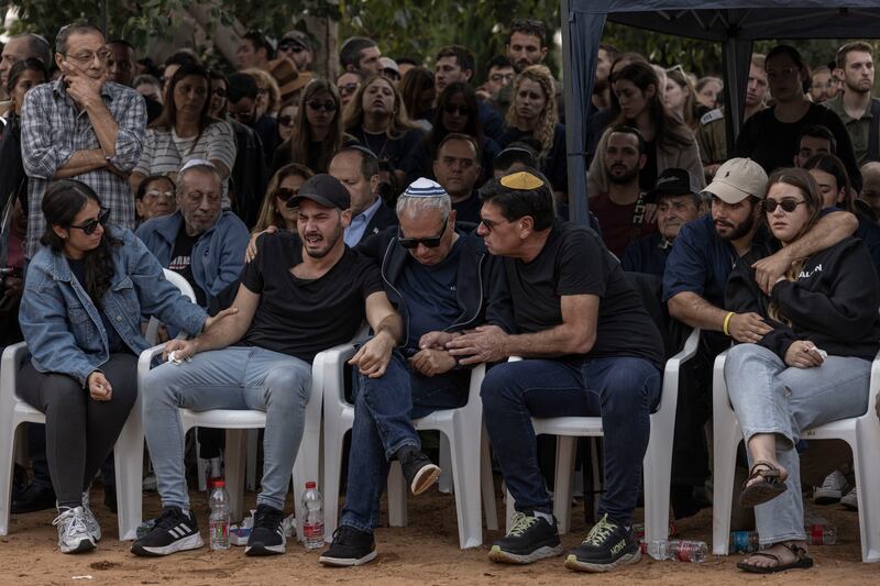 Alon Shamriz's father, Avi Shamriz (centre) mourns with other family members during his son’s funeral in Shefayim, Israel, on December 17th. Photograph: Avishag Shaar-Yashuv/New York Times