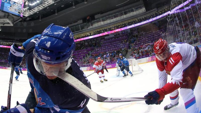 Yevgeni Malkin of Russia (right) hits Ossi Vaananen of Finland with his stick during the Men’s Ice Hockey quarter-final at the 2014 Sochi Winter Olympics at Bolshoi Ice Dome. Photograph: Martin Rose/Getty Images