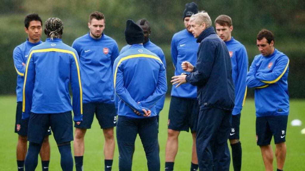 Arsenal manager Arsene Wenger speaks to his players during a training session at the club training centre in London Colney today. Photograph: Andrew Winning/Reuters