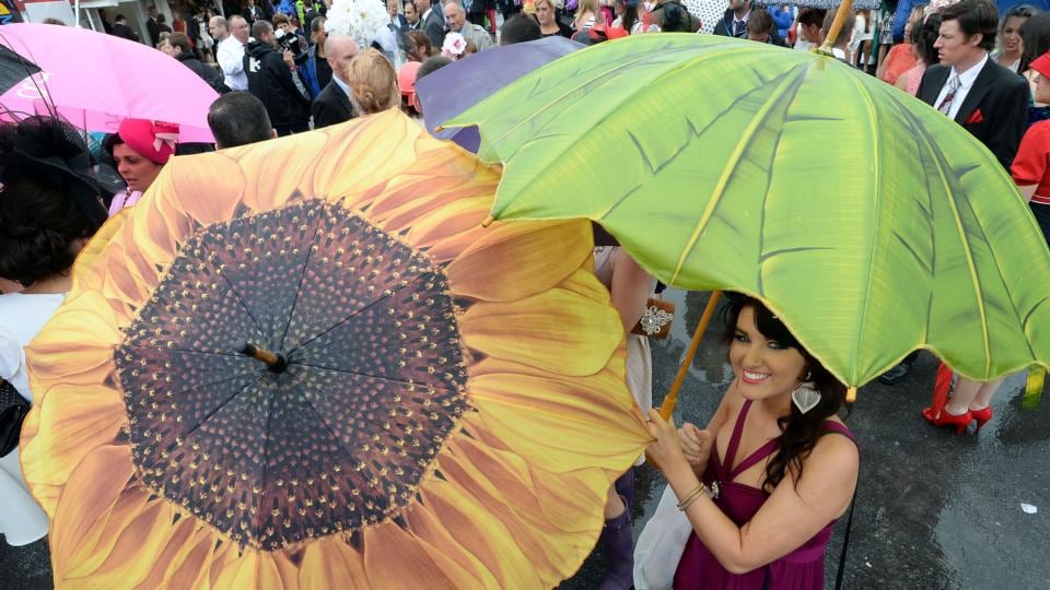 Caoimhe Groarke from Claremorris, Co Mayo, well covered in the rain during Ladies’ Day at the Galway races yesterday. An estimated three inches of rain fell during the meet. Photograph: Brenda Fitzsimons