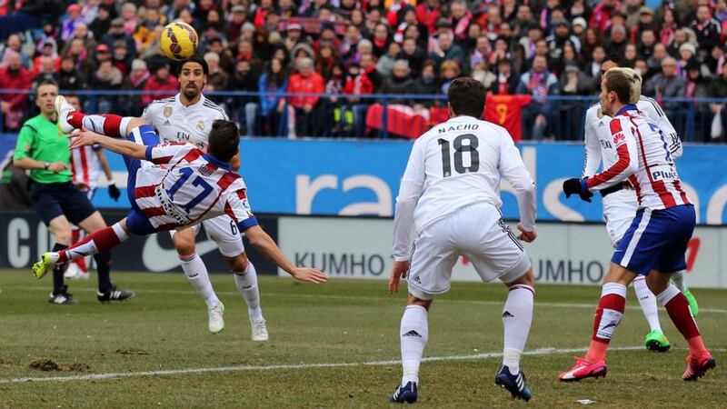 Atletico Madrid’s midfielder Saul Niguez (17) scores an overhead against Real Madrid at the Vicente Calderon Stadium. Photograph: Cesar Mansocesar / Getty Images