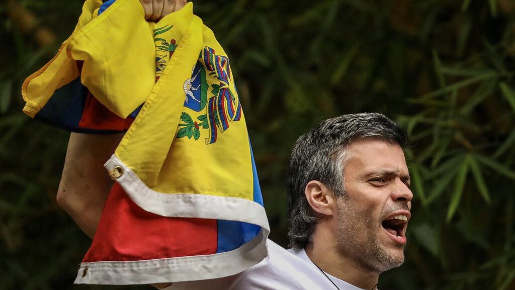 Opposition leader Leopoldo Lopez greets supporters from his home in Caracas, Venezuela, on July 8th. He was detained by security forces on Tuesday, after being previously jailed for inciting anti-government protests. Photograph: Miguel Gutierrez/EPA