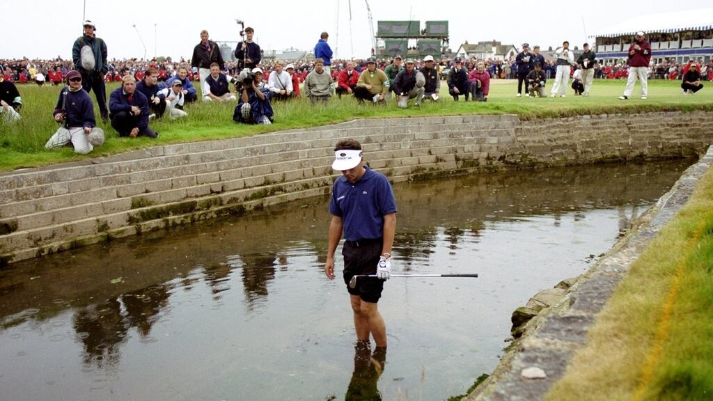 Jean van de Velde of France looks at his ball in the burn on the 18th hole during the final round of the 1999 British Open played at Carnoustie. Photo: Ross Kinnaird /Allsport