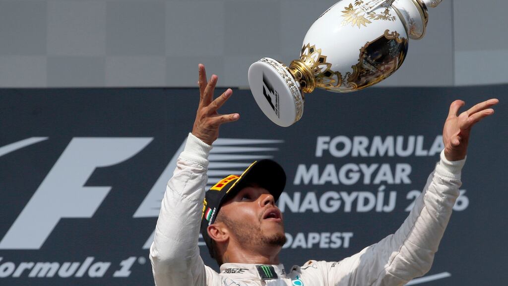Mercedes driver Lewis Hamilton of Britain celebrates after winning the Hungarian Formula One Grand Prix. Photo: Darko Vojinovic/Getty Images