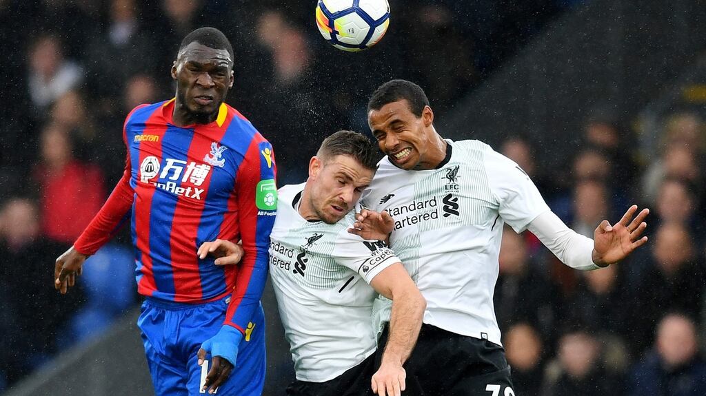 Crystal Palace’s Christian Benteke jumps for the ball with Liverpool’s Jordan Henderson and Joel Matip. Photo: Dylan Martinez/Reuters