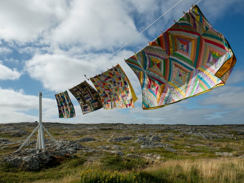 Wind lifts handmade quilts on a washing line on Fogo Island, Newfoundland, Canada. Photograph: Alex Fradkin