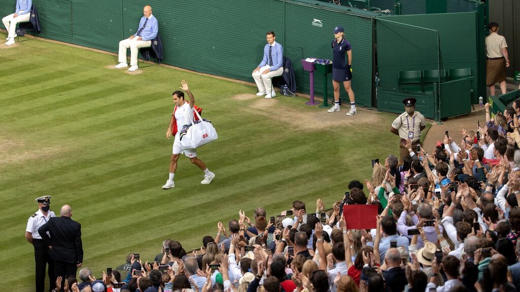 Roger Federer leaves Centre Court after his quarter-final defeat to Hubert Hurkacz. Photograph:  David Gray/PA