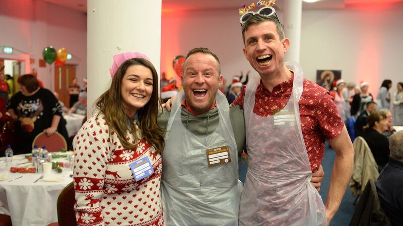 Volunteers Melissa O Donnell, Fran Byrne and Darren Carey, at the Knights of Columbanus Christmas dinner, in the RDS Dublin. Photograph: Dara Mac Dónaill / The Irish Times