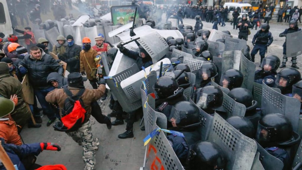 Protesters clash with riot police during their protest in Kiev, Ukraine last night. Photograph: Sergey Dolzhenko/EPA