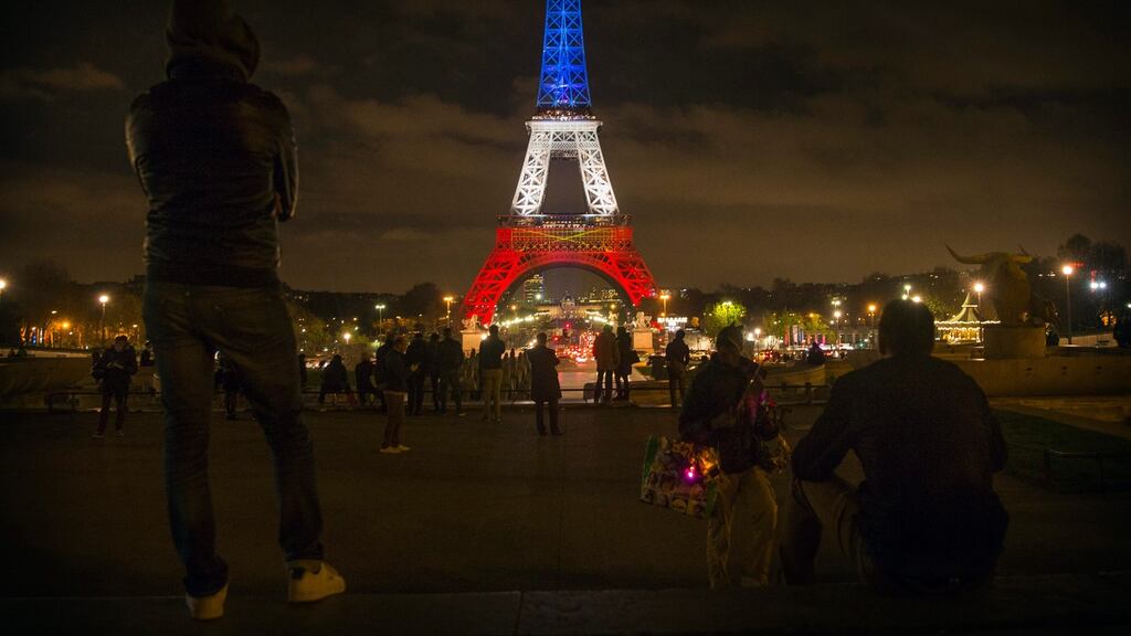 The Eiffel Tower is illuminated in the colors of the French flag in tribute for the victims of last Friday’s terror attacks. Photograph: Eteinne Laurent/EPA