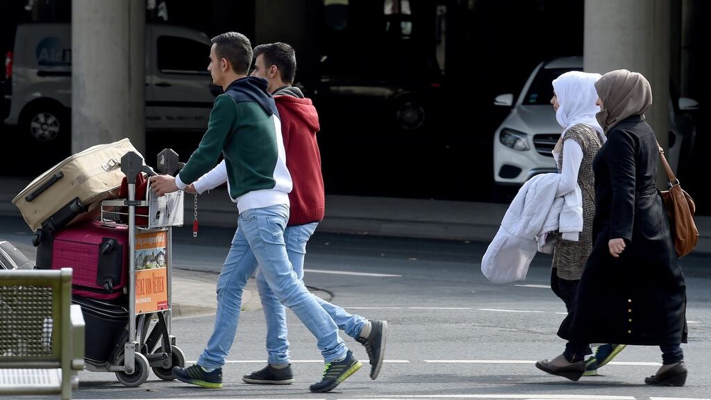 Syrian refugees arrive at Hannover Airport in  Germany on Monday under the controversial “one for one” plan. Photograph: Holger Hollemann/EPA