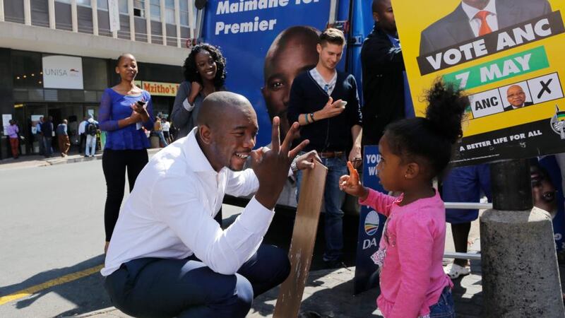 Democratic Alliance Gauteng Premier Candidate, Mmusi Maimane talks to a young girl while he launches the final phase of the DA’s posters for the South Africa general elections in  Johannesburg.  Photograph: Kim Ludbrook/EPA