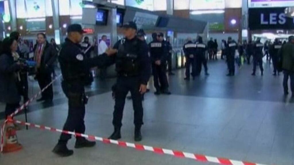 Police officers stand near the cordoned off spot where a French soldier was stabbed in the throat in the busy commercial district of La Defense, outside Paris, on Saturday. Photograph: Reuters TV.