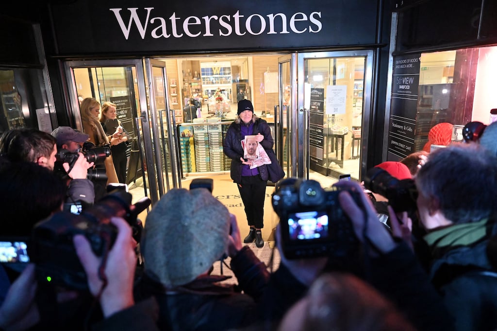 Midnight retail run: Caroline Lennon, “first” customer to buy Spare by Britain's Prince Harry, poses with her copy in front of the media outside Waterstones' flagship Piccadilly bookshop in London on the day of its release. Photograph: Justin Tallis/Getty