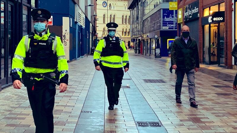 PSNI chief constable Simon Byrne (centre) and chief medical officer Dr Michael McBride (right) accompanied a routine patrol in Belfast city centre to ensure compliance with coronavirus regulations. Photograph: Chief constable Simon Byrne/PA Wire