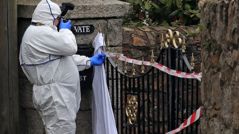 Gardaí examine spikes on the top of a gate where it is thought Michael Burke was accidentally impaled in a laneway off Convent Road in Dalkey on Friday morning. Photograph: Colin Keegan/Collins