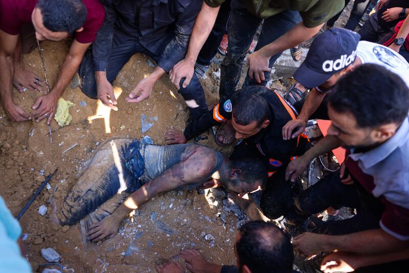 Emergency services and residents rescue a Palestinian man from the rubble of a house after an Israeli airstrike in Rafah, southern Gaza Strip. Photograph: /AFP via Getty Images