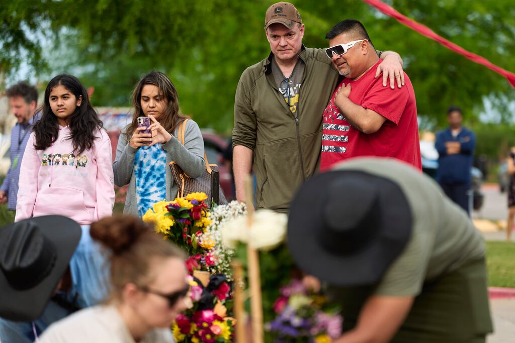 People gather for a vigil for victims of a shooting at the entrance to the Allen Premium Outlets in Allen, Texas, on Sunday. Photograph: Cooper Neill/The New York Times