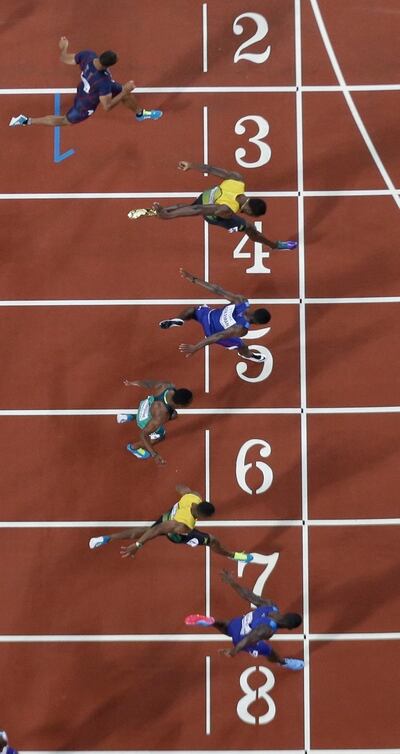 Justin Gatlin (bottom) crosses the line to win the men's 100m final. Photo: Getty Images