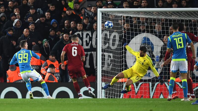 Liverpool goalkeeper Alisson Becker saves a shot from Napoli’s Arkadiusz Milik late in the game. Photograph: Paul Ellis/AFP/Getty Images