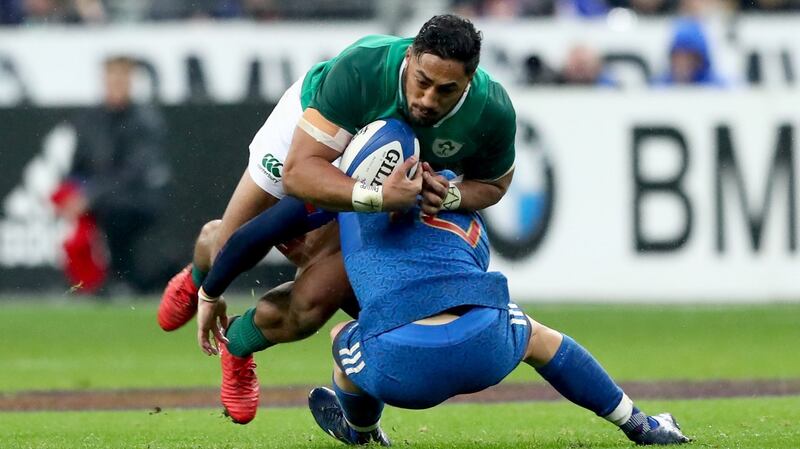 Ireland’s Bundee Aki is tackled by Matthieu Jalibert of France. Photograph: James Crombie/Inpho