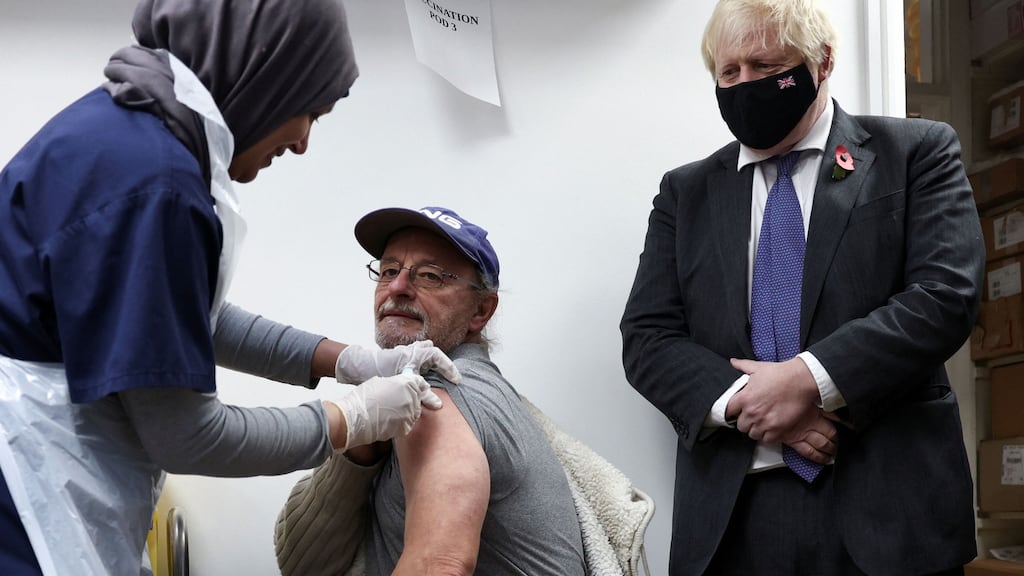 Britain’s prime minister Boris Johnson looks on as a health worker administers a Covid-19 vaccination at a pharmacy in Sidcup, south east London on November 12th. Photograph: Henry Nicholls/AFP via Getty Images