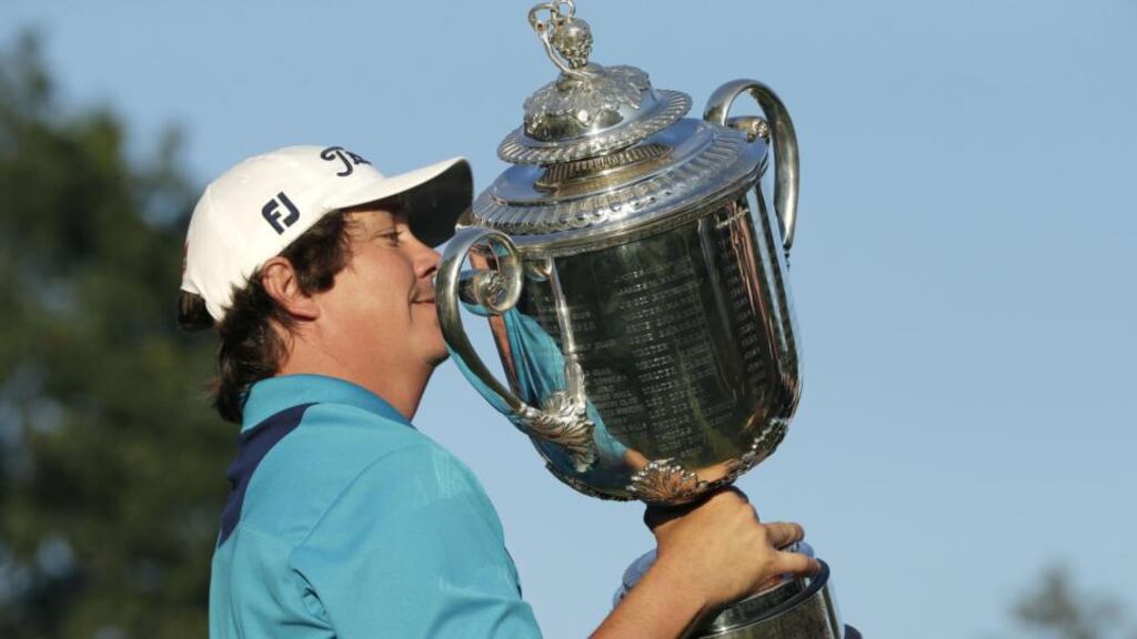 Jason Dufner holds up the Wanamaker Trophy after winning the PGA Championship golf tournament . Photograph: Charlie Riedel