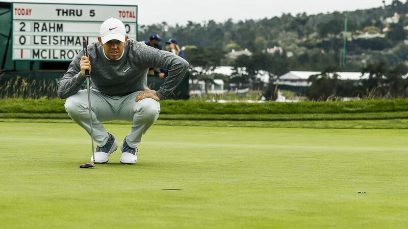 McIlroy lines up his putt on the sixth green during the second round. Photo: Etienne Laurent/EPA