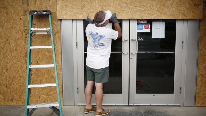 A worker boards up a gas station ahead of Hurricane Michael in Panama City Beach, Florida. Photograph: Luke Sharrett/Bloomberg