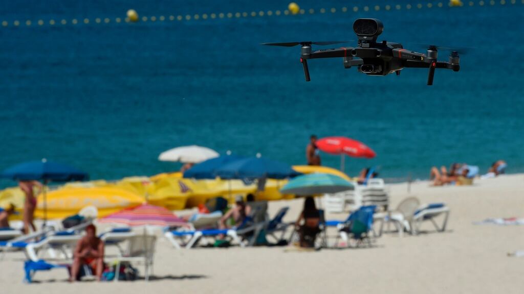 A droplet in the ocean: police drones fly over the Areas beach in northwestern Spain. Photograph: Miguel Riopa/AFP