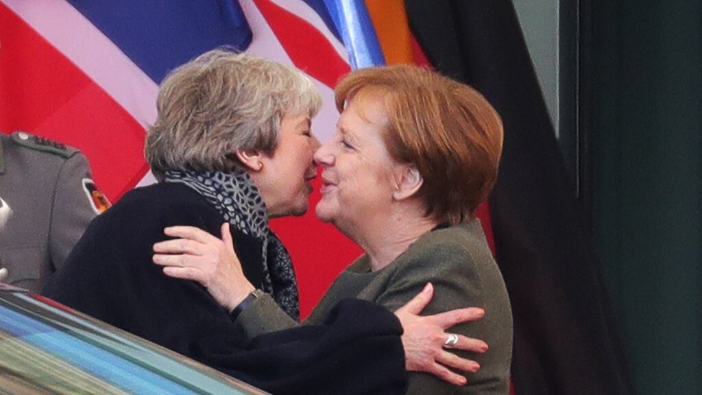 British prime minister Theresa May embraces chancellor Angela Merkel in Berlin on Tuesday. Photograph: Krisztian Bocsi/Bloomberg