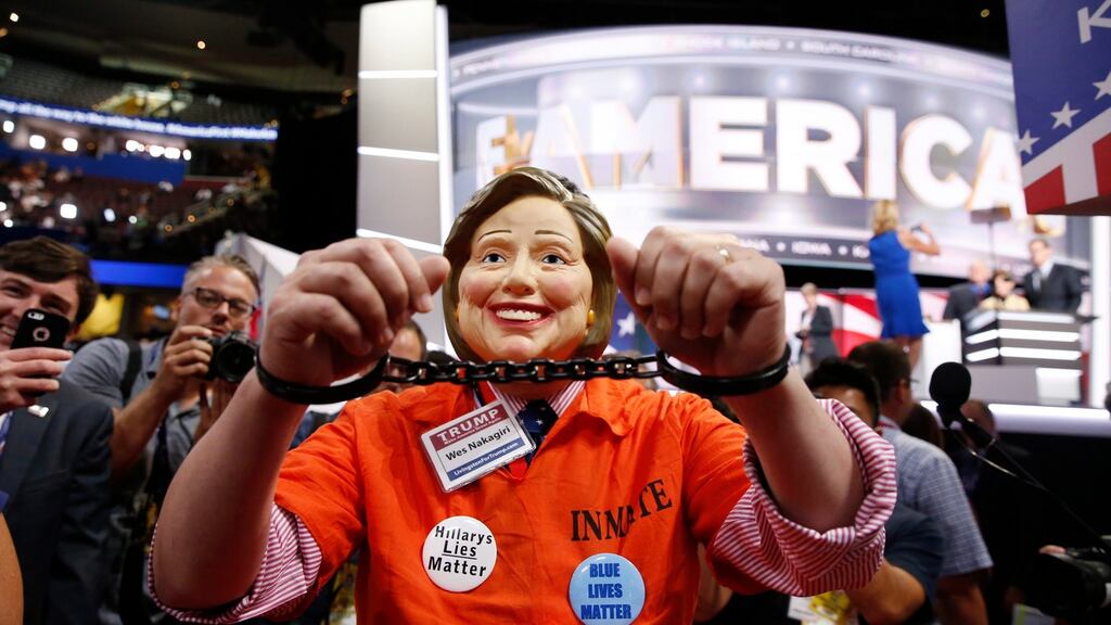 Michigan delegate Wes Nakagiri wears a Hillary Clinton mask, and handcuffs, before the start of the final day of the Republican National Convention in Cleveland, Ohio. Photograph: Michael Reynolds/EPA