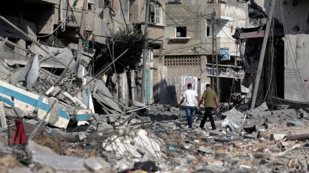 Palestinians walk amid the rubble of houses destroyed by Israeli strikes in Beit Hanoun, northern Gaza Strip, yesterday. Photograph: Lefteris Pitarakis/AP