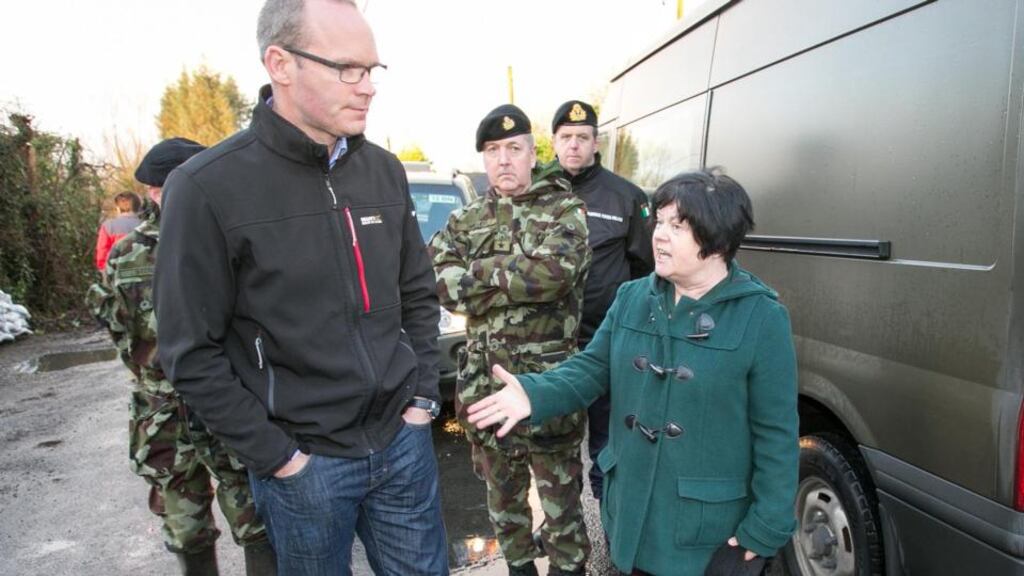 Minister for Defence Simon Coveney talks with Clonlara resident Geraldine Mason. Photograph: Arthur Ellis