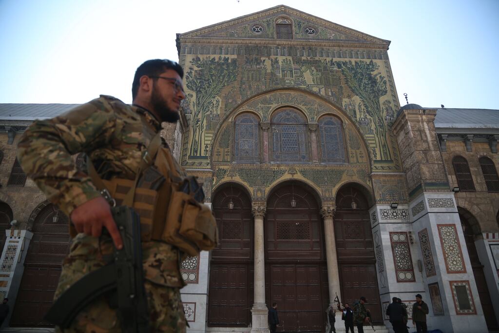 An armed rebel outside the Umayyad Mosque in Damascus, Syria. Photograph: Bilal Alhammoud/EPA