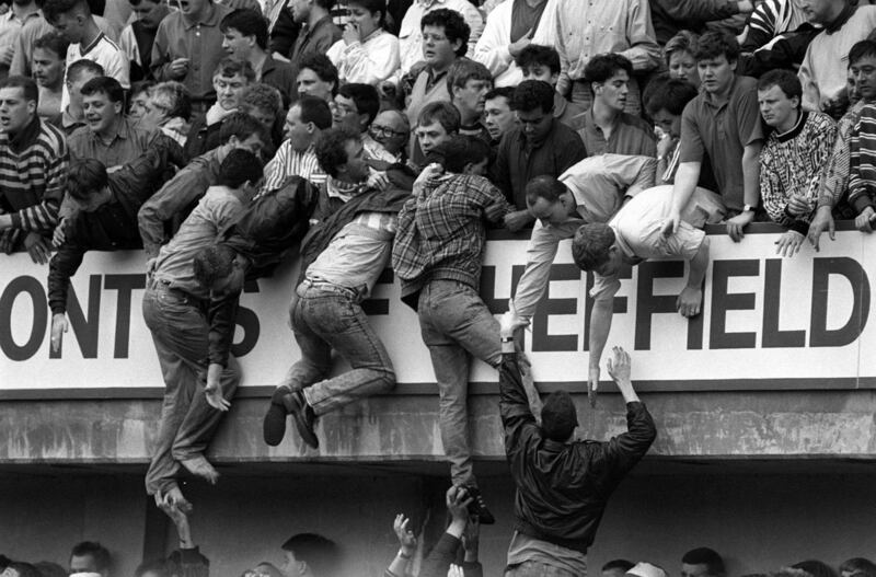 File photo dated April 15th, 1989 of Liverpool fans climbing into the upper West Stand in an attempt to escape severe overcrowding in the Leppings Lane terrace below during the FA Cup semi-final football match between Liverpool and Nottingham Forest at Hillsborough. Photograph: David Giles/PA Wire