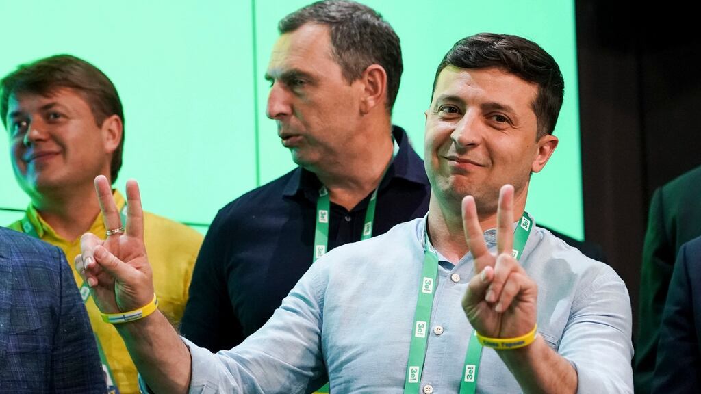 Ukrainian president Volodymyr Zelenskiy, right. With 79 per cent of votes counted, Mr Zelenskiy’s Servant of the People party was set to claim about 253 of 424 available seats. Photograph: Evgeniy Maloletka/AP