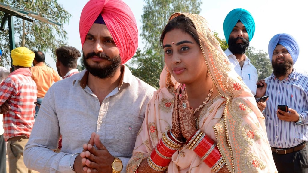 Sikhs offer prayers as they look towards the Gurdwara Kartarpur Sahib in Pakistan after an accord was signed on a visa-free India-Pakistan Kartarpur corridor. Photograph: Narinder Nanu/AFP