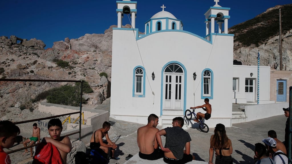Children gather in front of a Greek Orthodox church on the Aegean Sea island of Milos, Greece, on Sunday. Photograph: AP