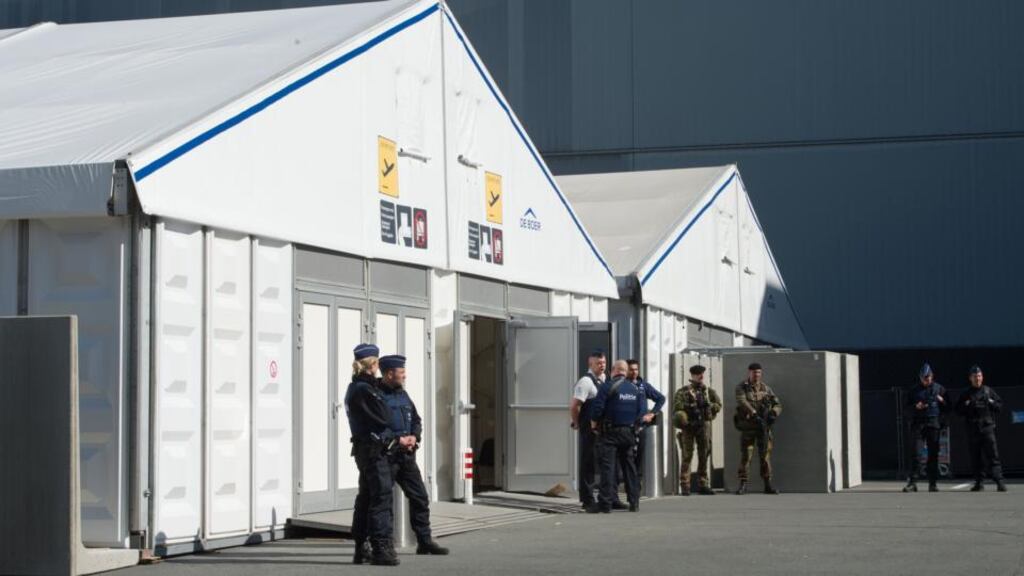 Policemen and soldiers stand guard outside temporary check-in desks at Brussels airport in Zaventem. Photograph: AFP/Getty Images