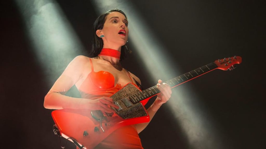 St Vincent: imperious in orange PVC, Annie Clark manipulates a selection of primary-colour guitars with demonic zest. Photograph: Dave Meehan