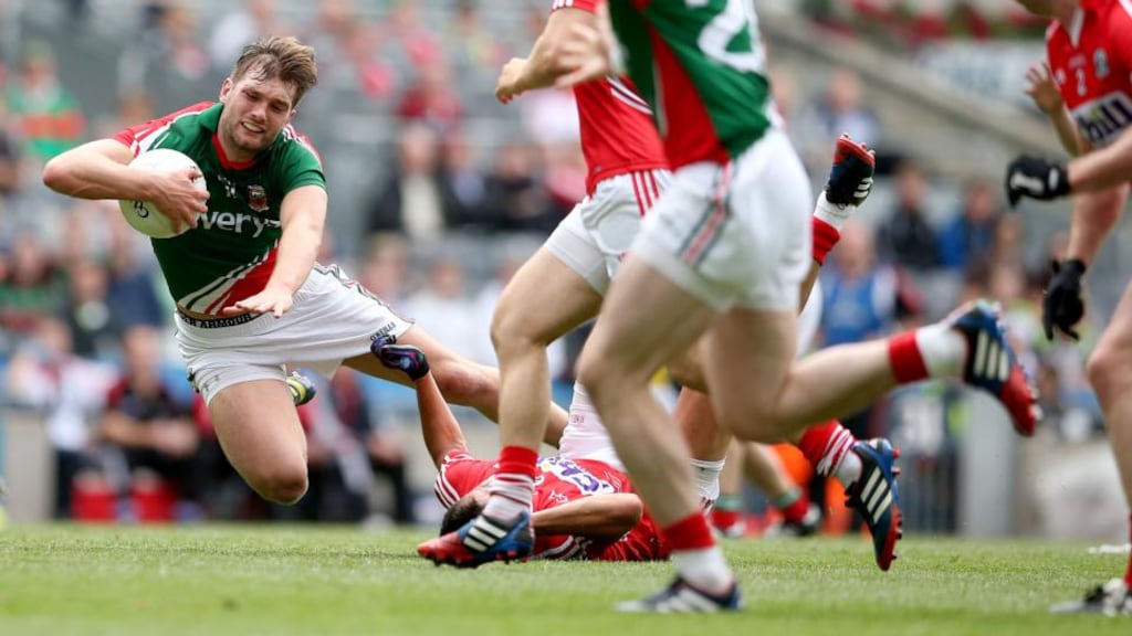 Mayo’s Aidan O’Shea tackled by Tomás Clancy, which resulted in the Cork player receiving a black card. Photograph: James Crombie/Inpho