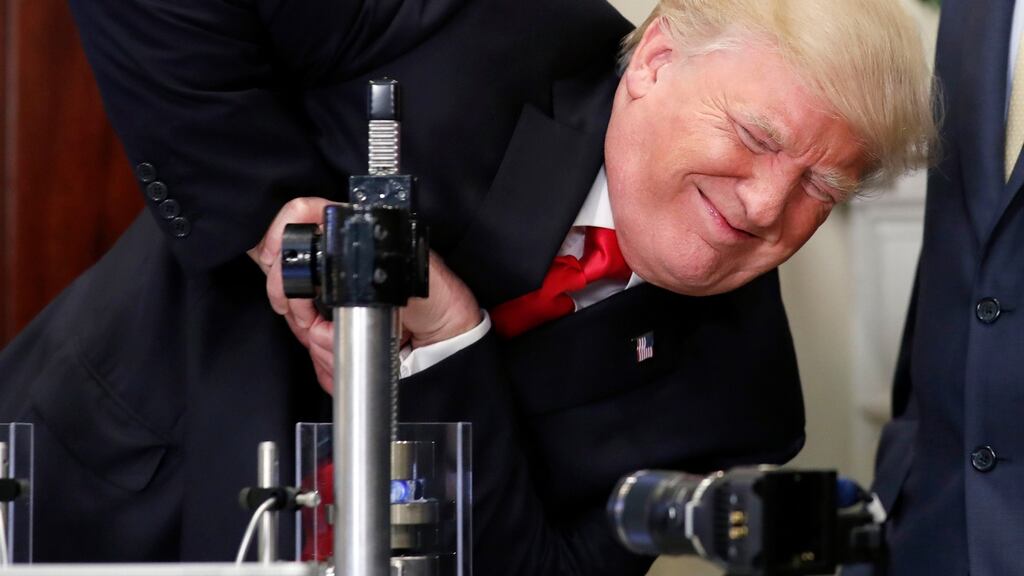 President Donald Trump attempts to crush a glass protective vial: as he settles into office, he has relatively few legislative wins to show. Photograph: Alex Brandon/AP