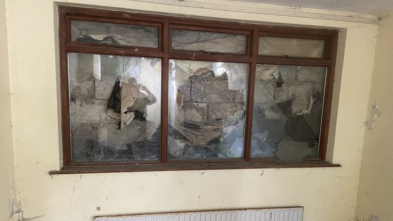 A picture window shuttered by breeze blocks.