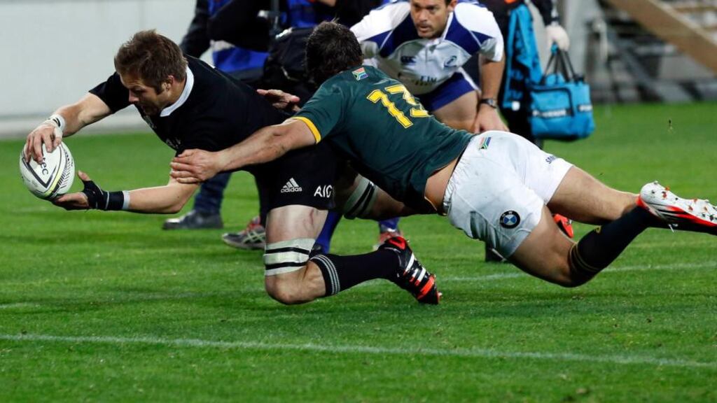 New Zealand captain Richie McCaw stretches past the tackle of South Africa’s Jan Serfontein to score a try in the second half of the Rugby Championship match at Westpac Stadium in Wellington. Photograph: Anthony Phelps/Reuters
