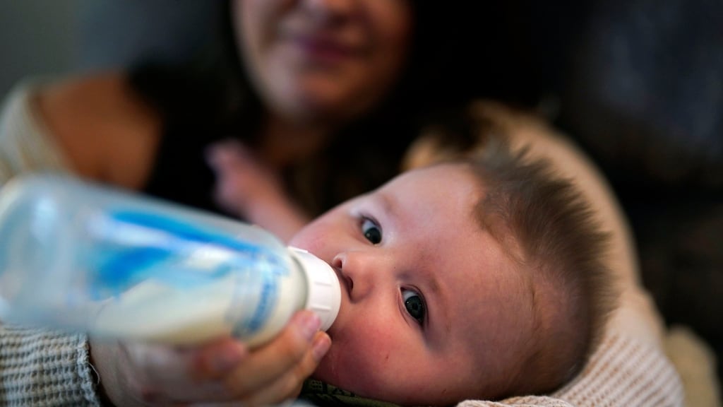 Ashley Maddox feeds her five-month-old son, Cole, with formula she bought through a Facebook group of mothers in need in California. Photograph: Gregory Bull/AP Photo